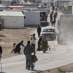 Syrian refugees walk at the Al Zaatari refugee camp in the Jordanian city of Mafraq, near the border with Syria, December 7, 2014. A lack of funds has forced the United Nations to stop providing food vouchers for 1.7 million Syrian refugees in Jordan, Lebanon, Turkey, Iraq and Egypt, the World Food Programme (WFP) said on December 1. Suspension of the assistance programme comes as many vulnerable Syrian families enter their fourth bleak winter in difficult living conditions after fleeing a homeland racked by conflict since March 2011. REUTERS/Muhammad Hamed (JORDAN - Tags: SOCIETY IMMIGRATION POLITICS CIVIL UNREST)