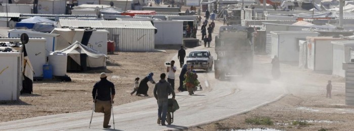 Syrian refugees walk at the Al Zaatari refugee camp in the Jordanian city of Mafraq, near the border with Syria, December 7, 2014. A lack of funds has forced the United Nations to stop providing food vouchers for 1.7 million Syrian refugees in Jordan, Lebanon, Turkey, Iraq and Egypt, the World Food Programme (WFP) said on December 1. Suspension of the assistance programme comes as many vulnerable Syrian families enter their fourth bleak winter in difficult living conditions after fleeing a homeland racked by conflict since March 2011. REUTERS/Muhammad Hamed (JORDAN - Tags: SOCIETY IMMIGRATION POLITICS CIVIL UNREST)