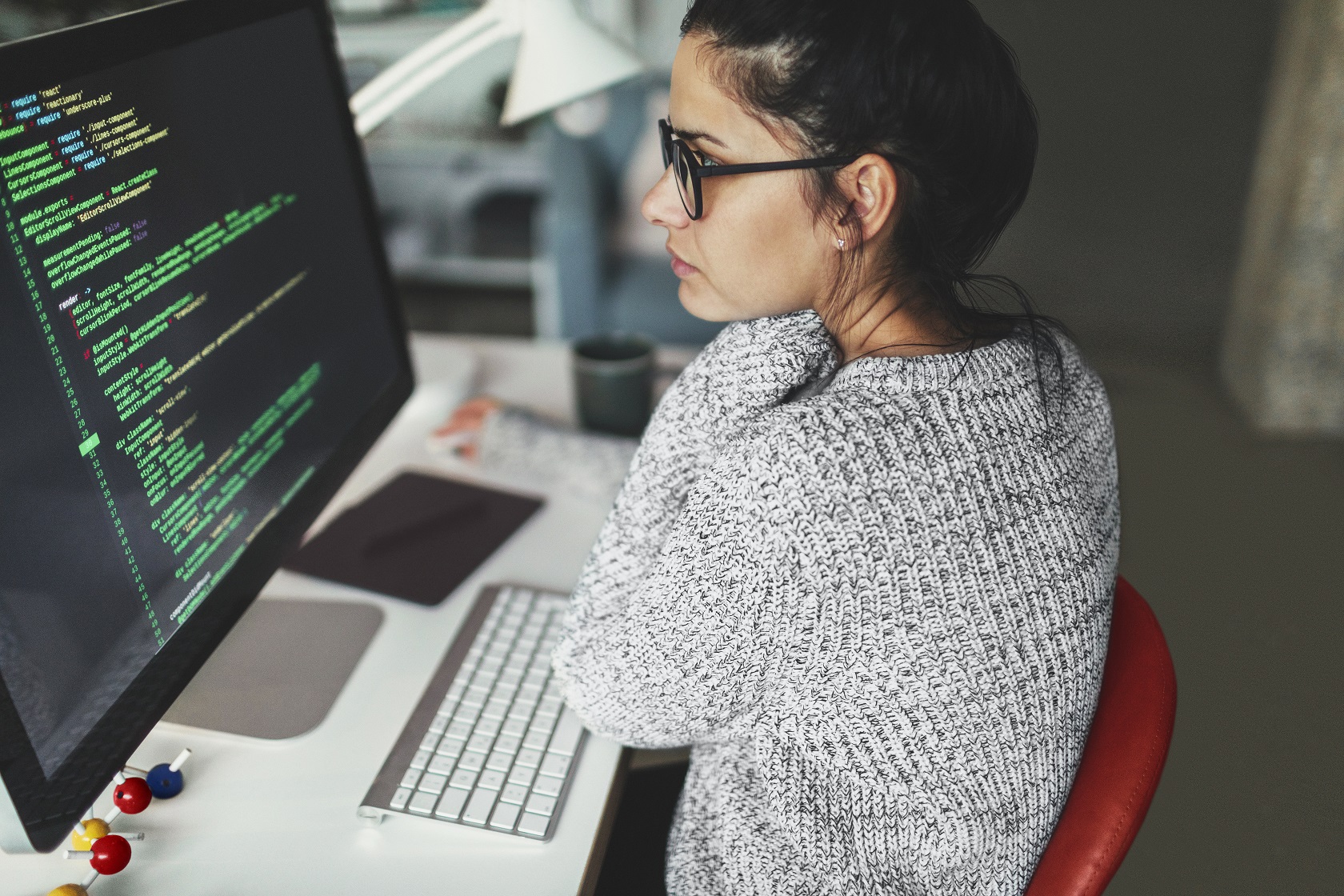 Young woman programming at her home office