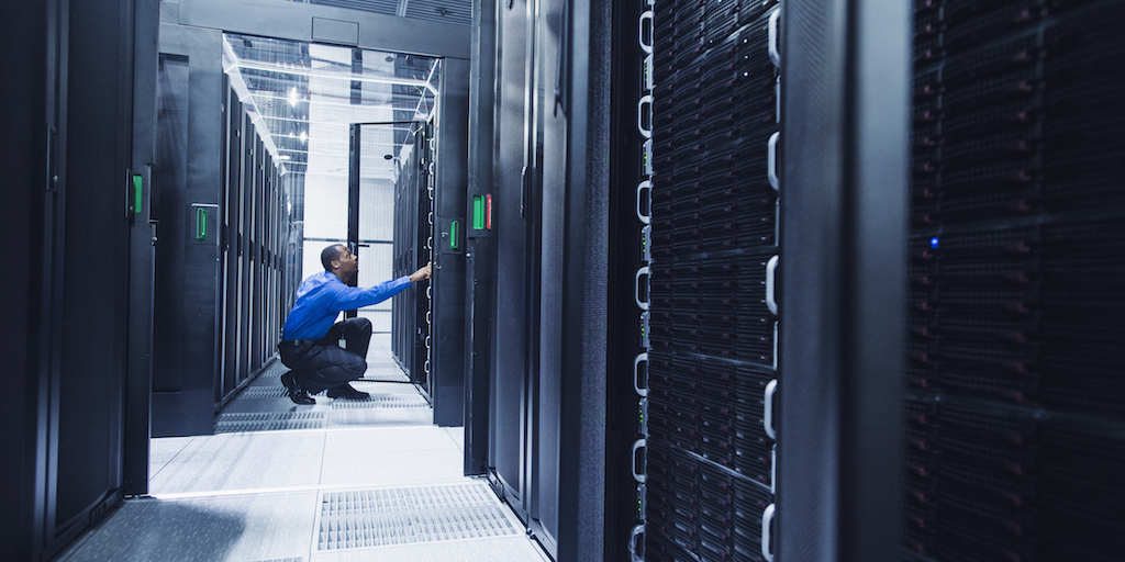 Black businessman working in server room