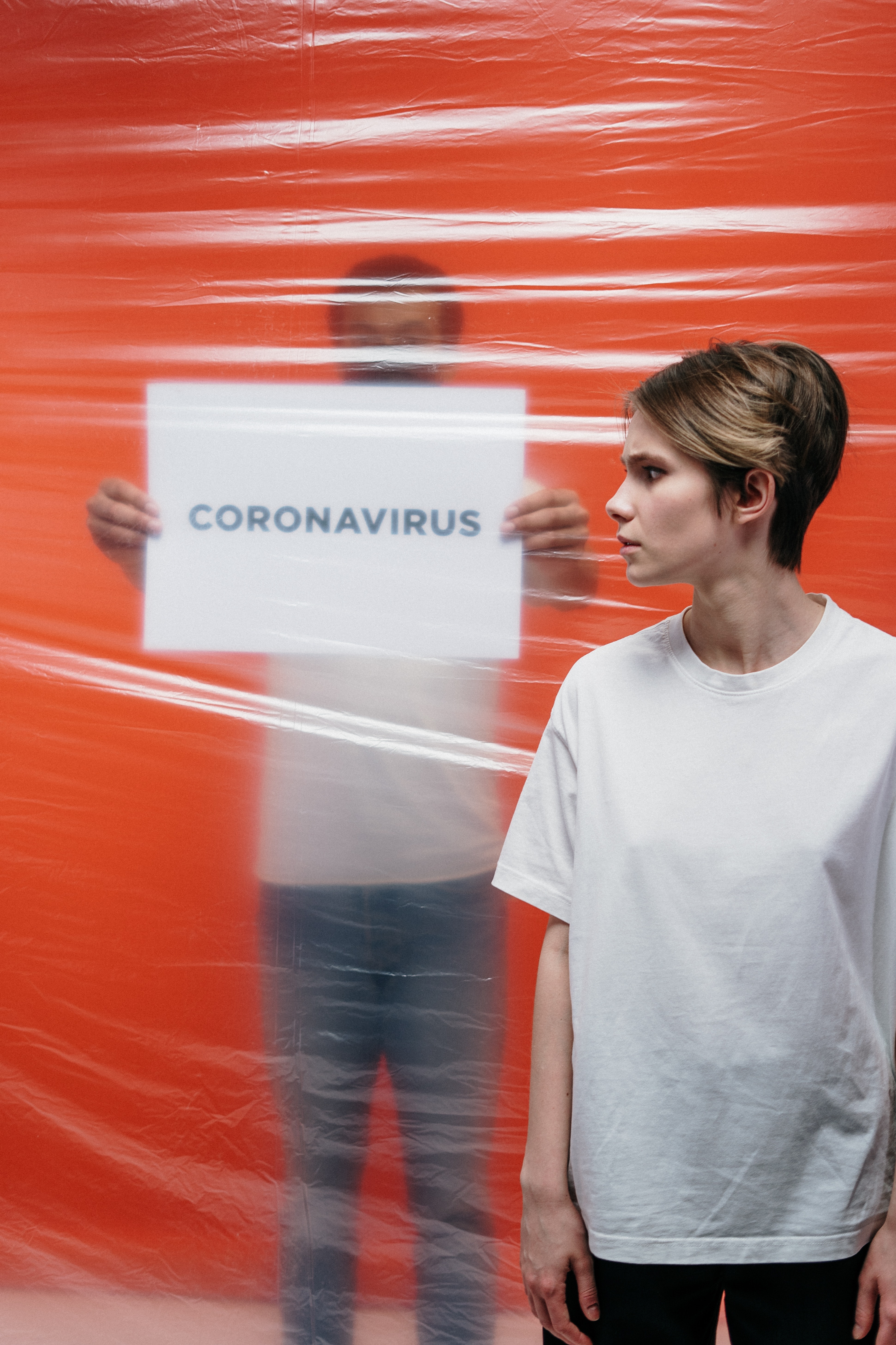 woman-with-a-stressful-look-at-a-man-holding-a-poster-with-3952186