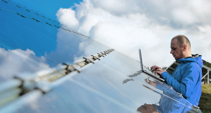 man with-laptop-on-solar-panels