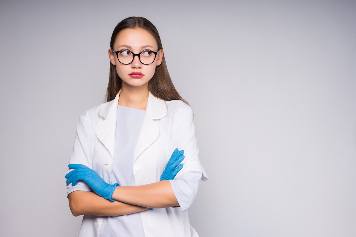 girl nurse with glasses folded her arms looking away