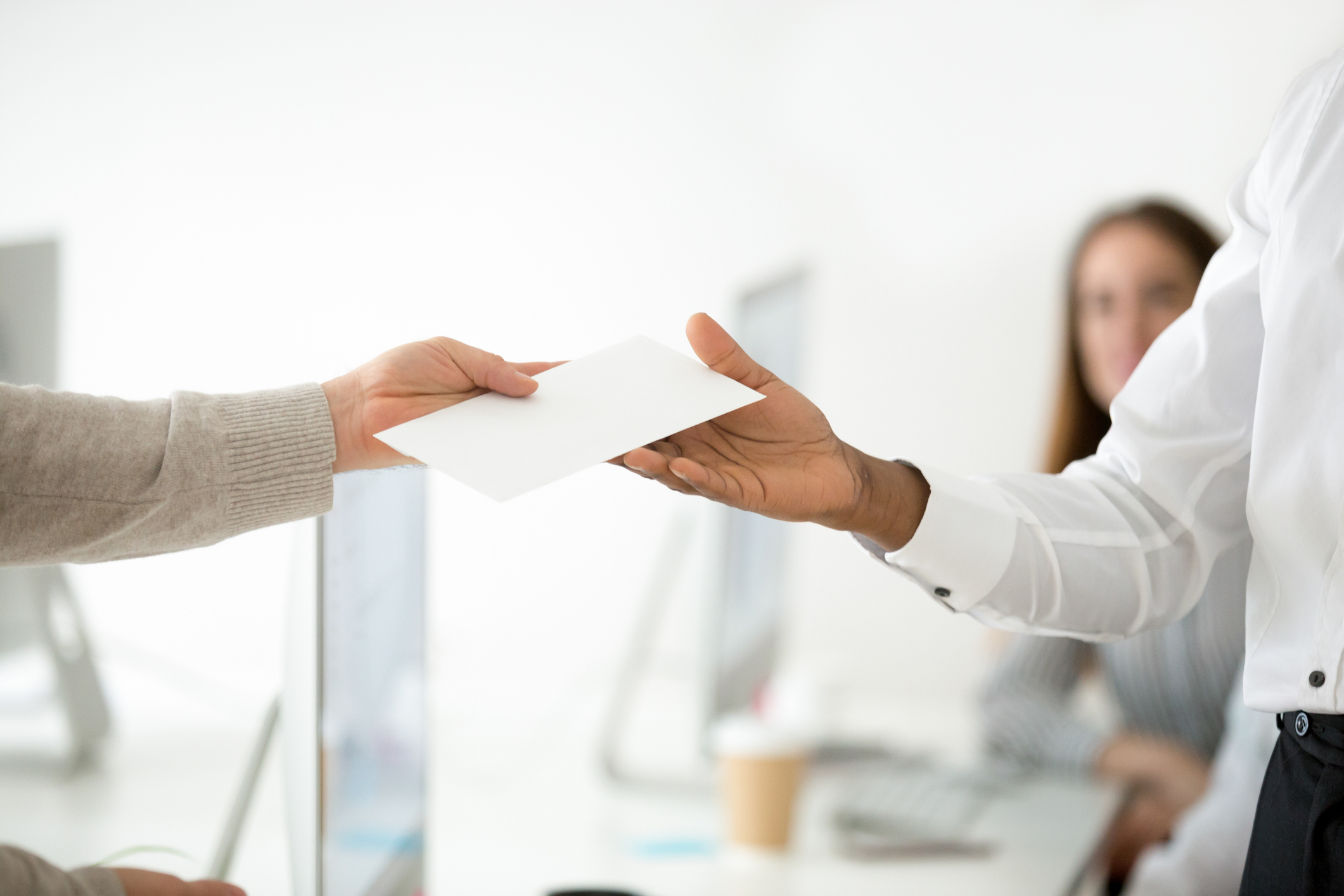 Close up of boss rewarding successful worker with money bonus