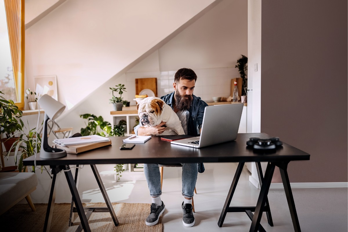 ey-freelancer-working-from-home-with-dog-in-his-lap-background.jpg.rendition.1200.1800