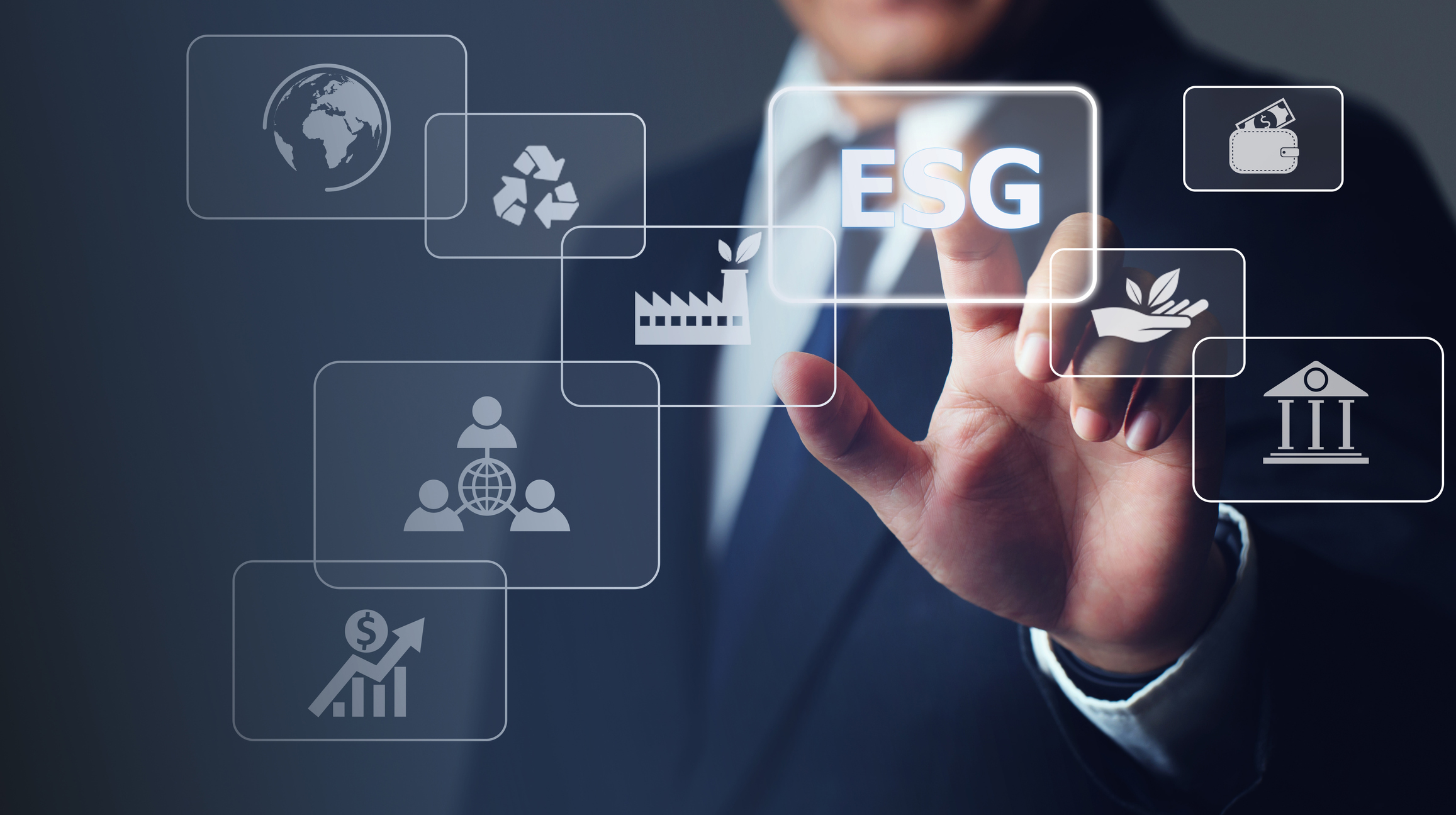 Businessman touching button ESG on-screen with connected virtual icons over the background.ESG environmental social governance business strategy investing concept.