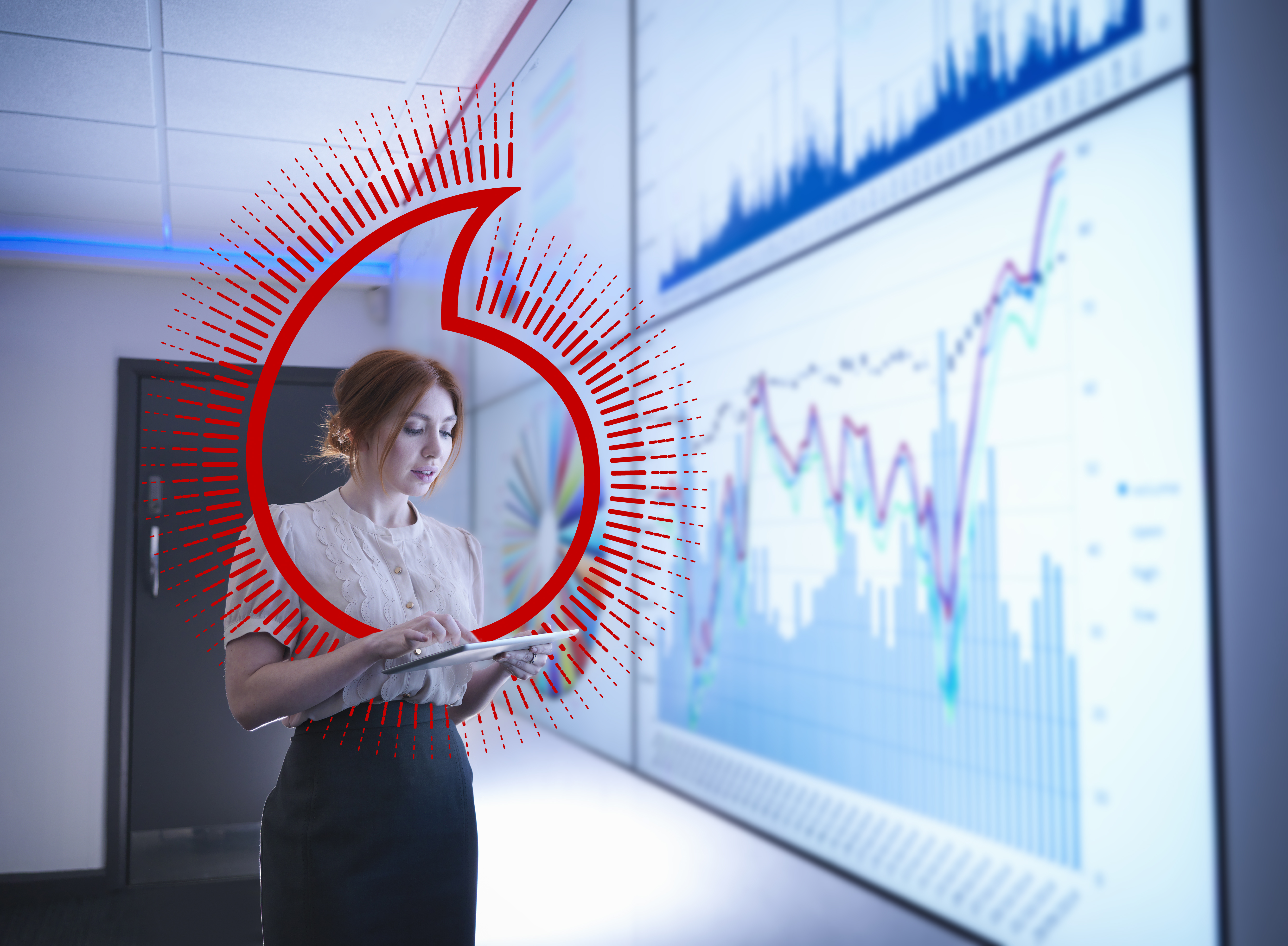 Businesswoman studying graphs on screen with digital tablet