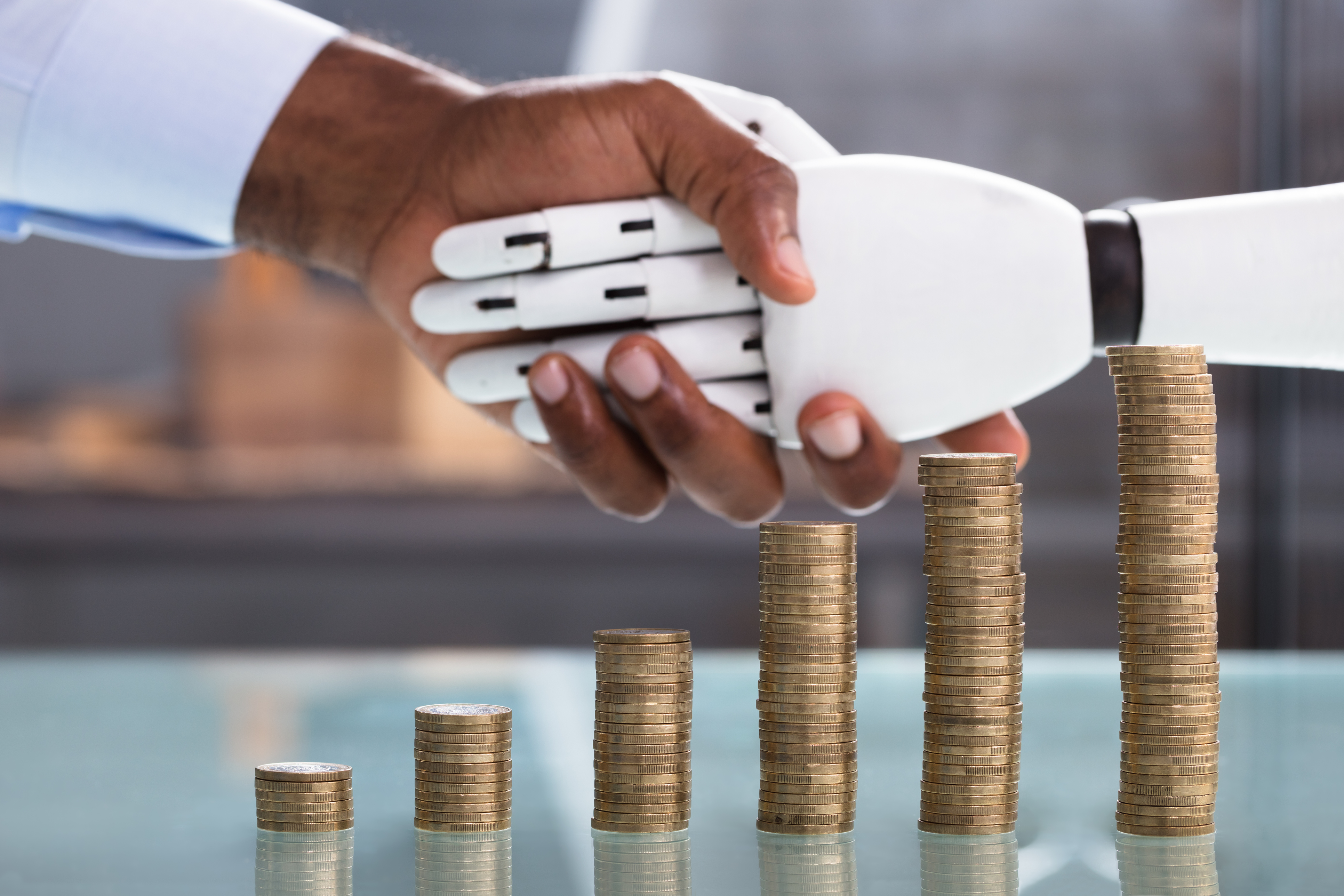 Man Shaking Hand With Robot With Coin Stack