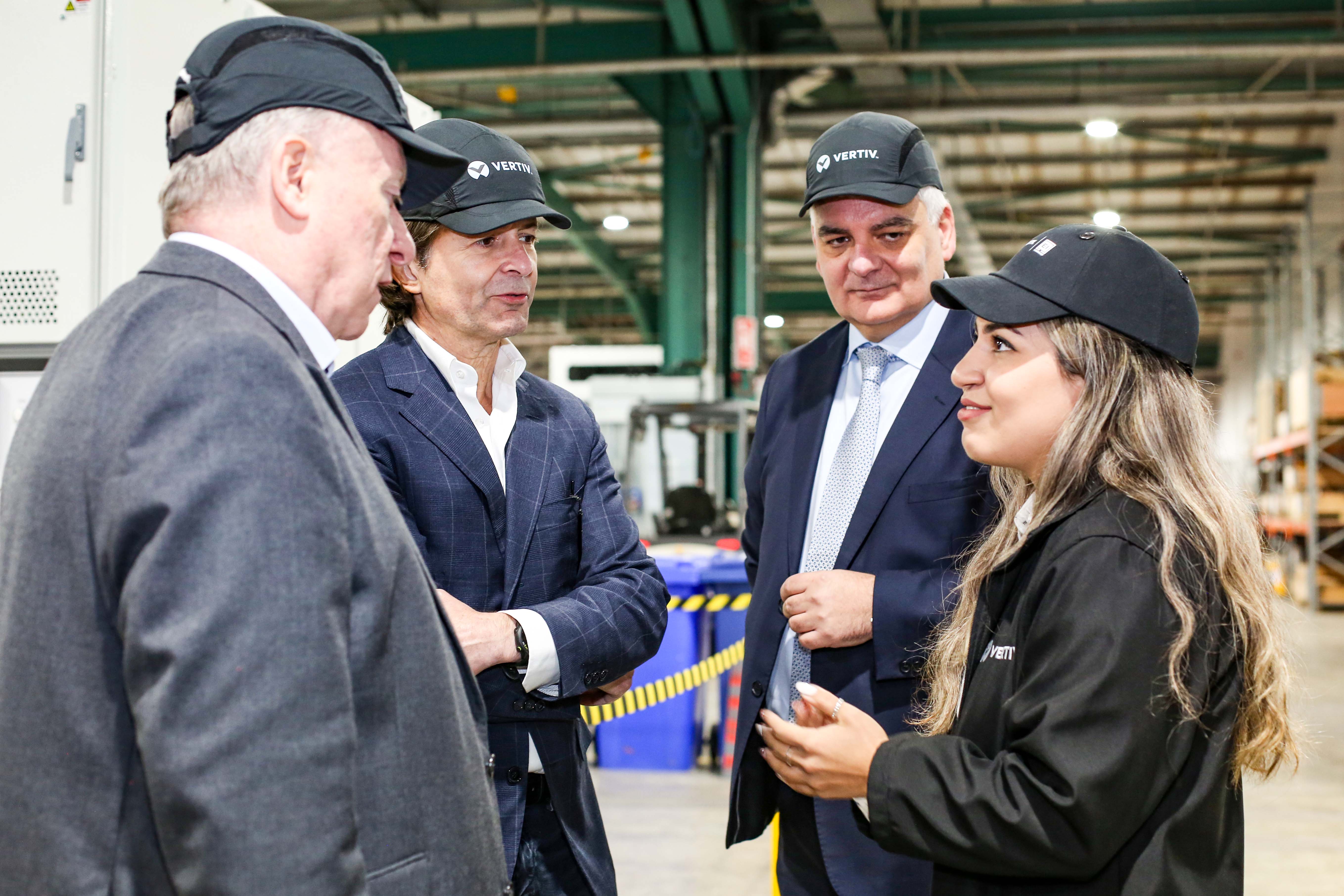 Vertiv jobs announcement Philip O’Doherty, managing director of E&I business, Vertiv, Giordano Albertazzi, Vertiv CEO, and Mel Chittock, interim CEO, Invest NI chatting to Melika Azhdari, MV Project manager, during a tour of the Campsie site following the announce of approx. 200 new jobs. Credit © Lorcan Doherty